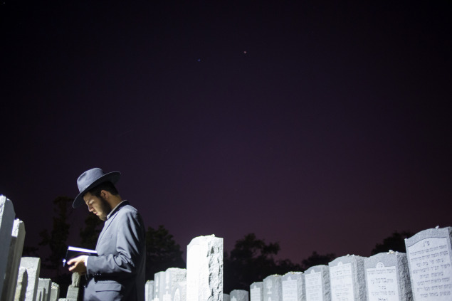 A visitor prays at the gravesite of the Rebbe, Rabbi Menachem Mendel Schneerson. (Photo via Getty Images)